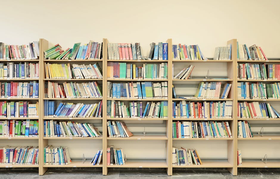 Well-organized bookshelf filled with colorful academic books in a library.